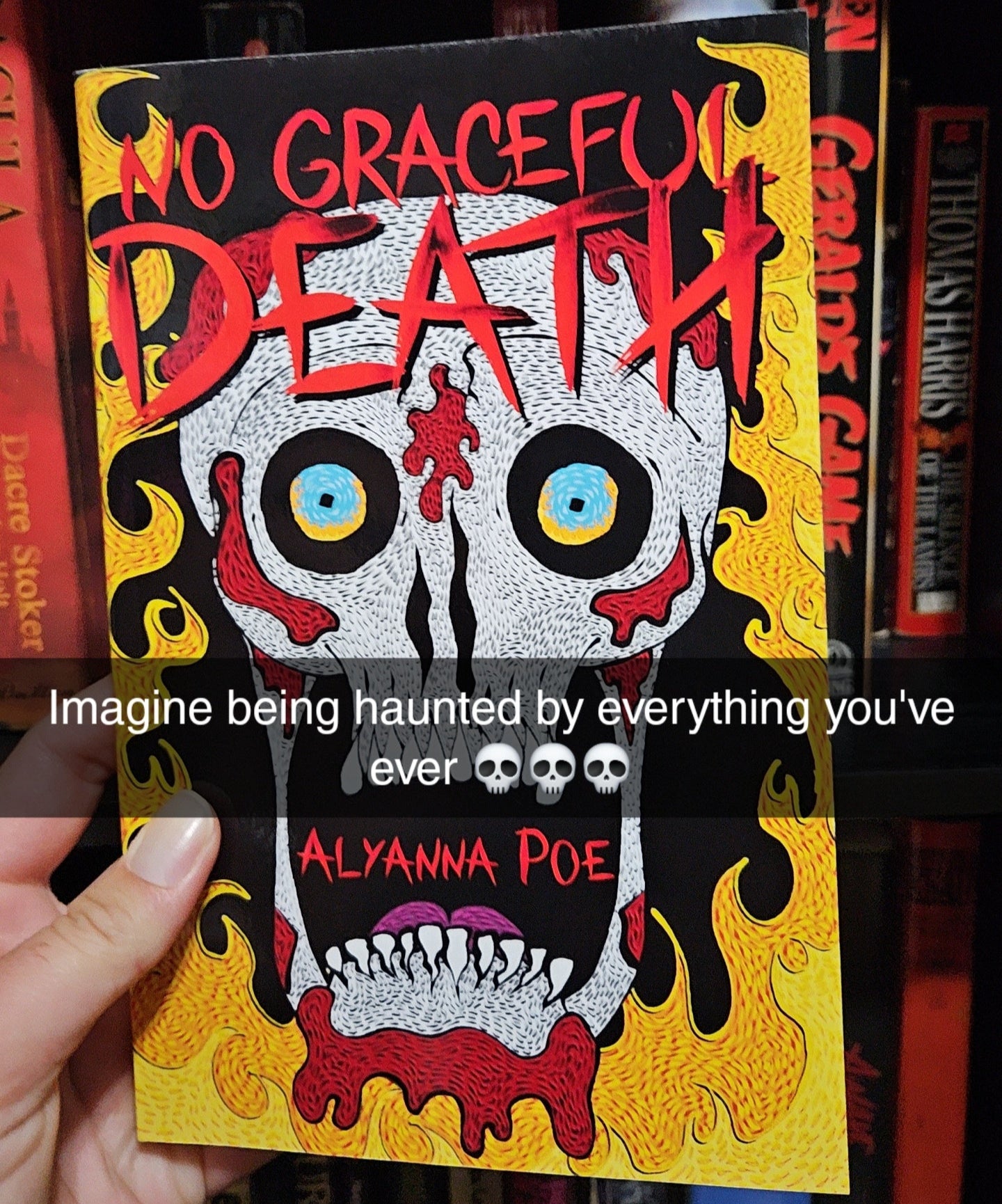 Book titled 'No Graceful Death' held by a hand with other books in the background